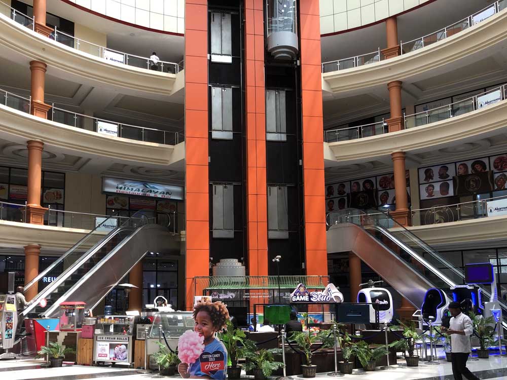 Akamwesi Shopping Mall Uganda. Location Kyebando, Kampala Uganda. Services: Space to Let/Rent, Offices, Super Market, Fashion Shops/Clothes Stores, Bars and Restaurants, ATMs, Bridal/Wedding Gardens (Akamwesi Gardens), Kids Play Park-Lloli Fun Park, Soccer Turf/Soccer Pitch, Swimming Pool, Sauna and Steam Bath, Gym, Beauty Salons, Electronics And Phone Stores, Furniture Stores, Car Washing Bays. Location: Kyebando, Gayaza Road, Akamwesi Mall Kampala Uganda. doorsug.com