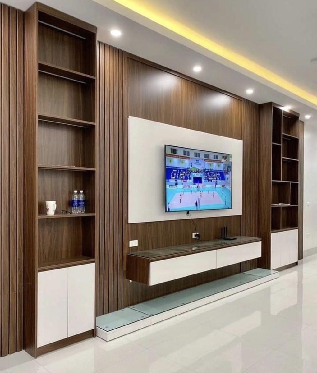 TV unit design in Kampala Uganda. Stylish modern wood TV wall unit installation in Uganda. Trust Interiors Uganda. Leading interior design company in Uganda. Services: Interior design services, installation services, manufacturing of modern stylish furniture products in Uganda, East Africa. ugabox.com